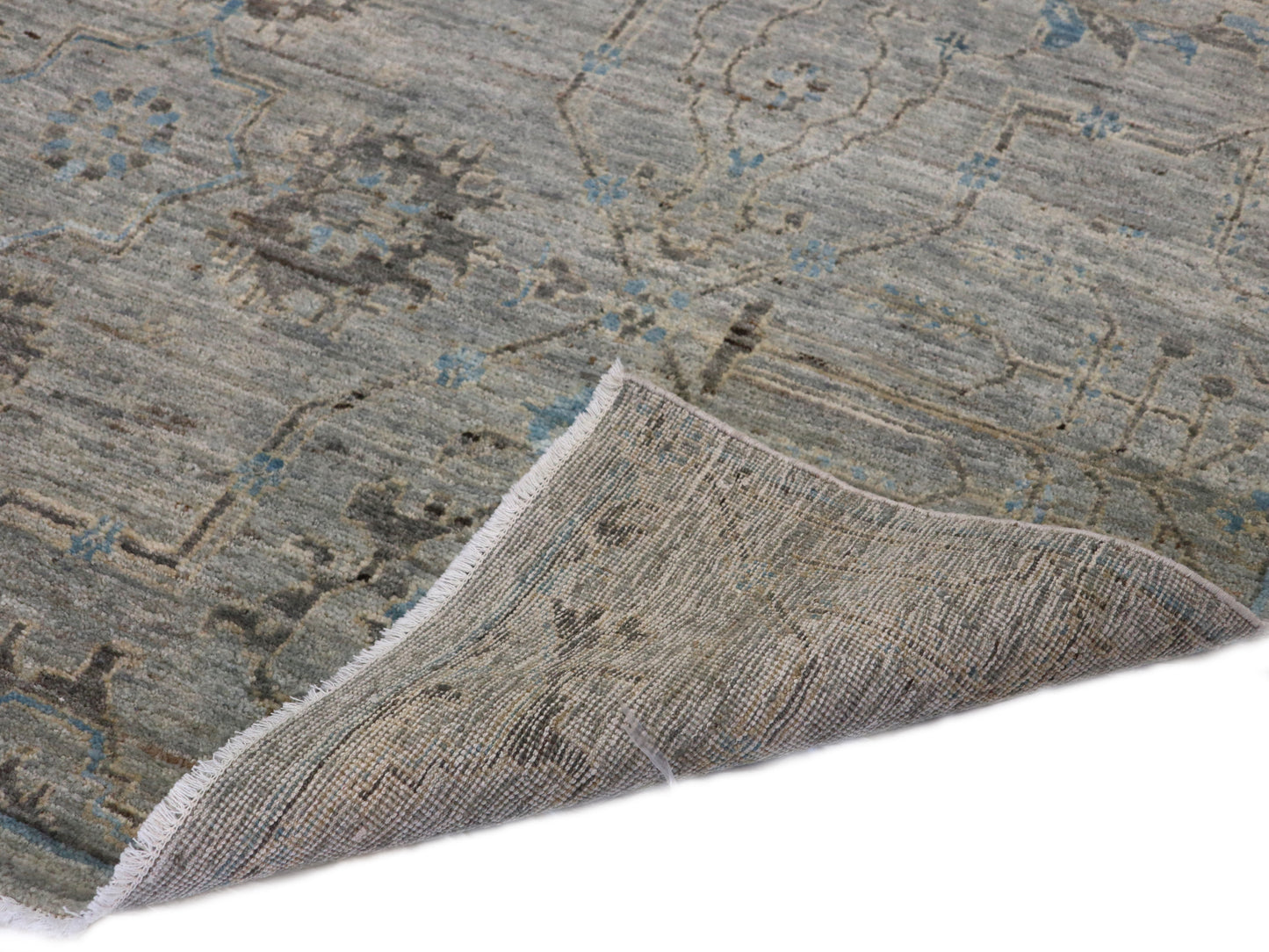 Hand-knotted rug in tranquil coastal shades of gray, smokey green, blue, soft yellow, and brown