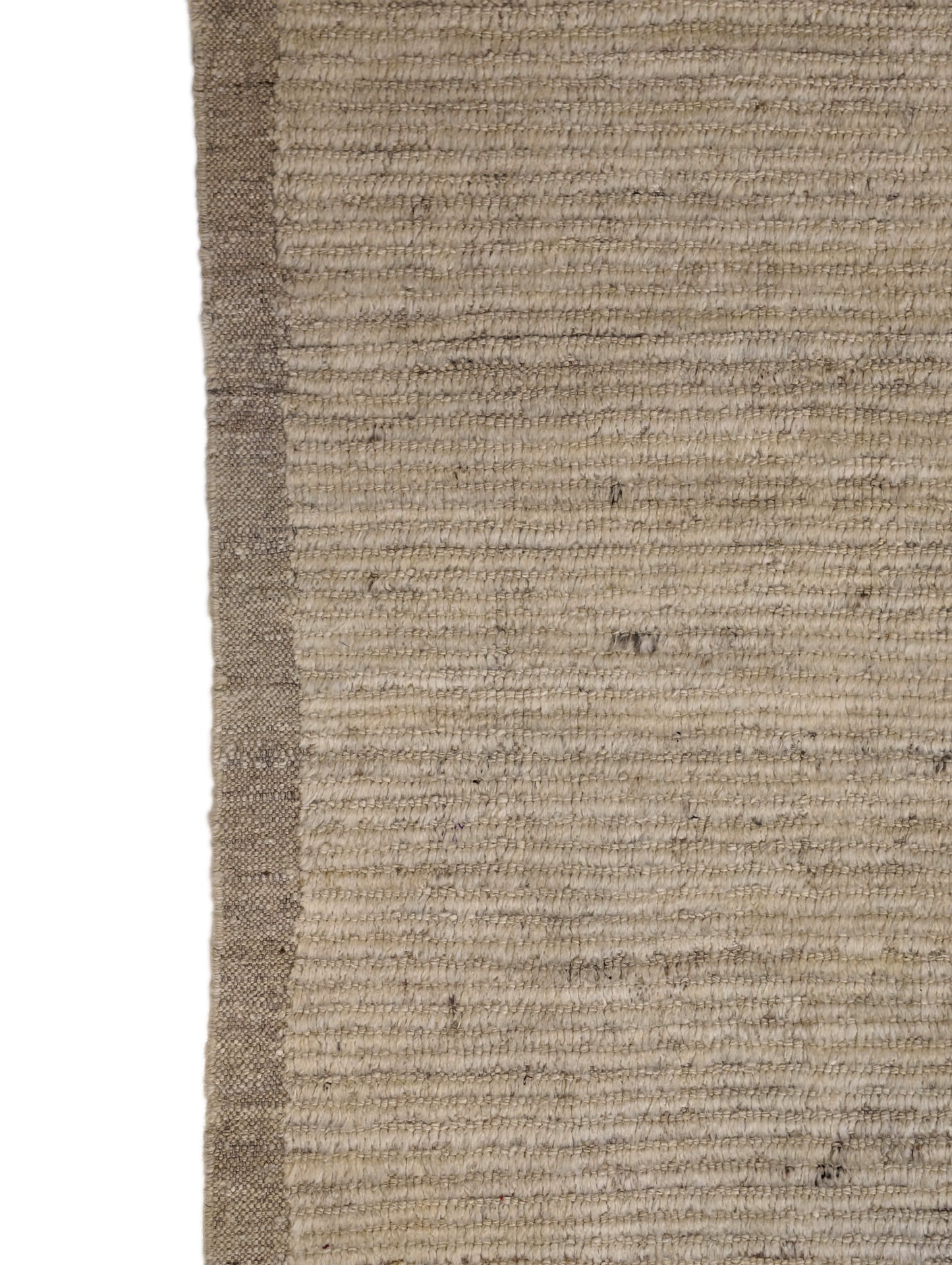 A hand-knotted wool rug in beige, ivory, and cream colors with a coastal aesthetic and a plush appearance.