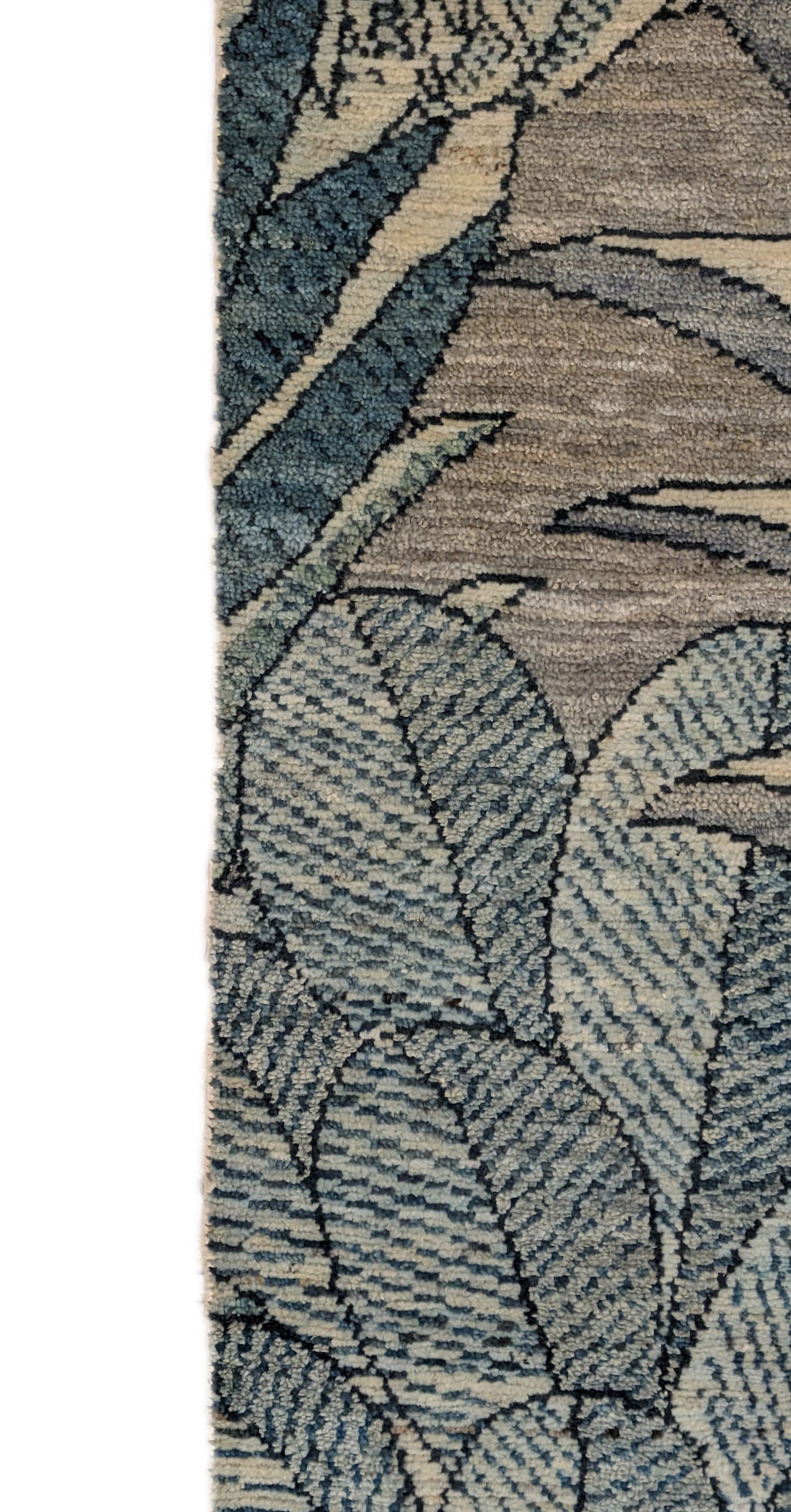 A hand-knotted wool rug with a coastal-inspired floral and plant design in shades of beige, gray, blue, green, and black.
