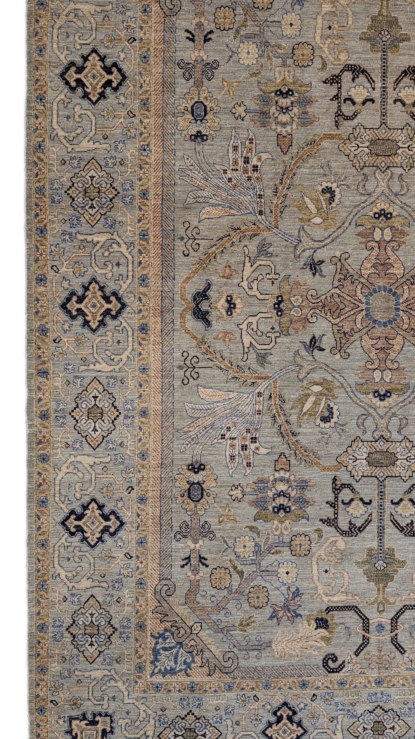A hand-knotted wool rug with a coastal palette of beige, navy, rosy pink, blue, gold, and ivory colors, featuring intricate traditional and contemporary patterns.
