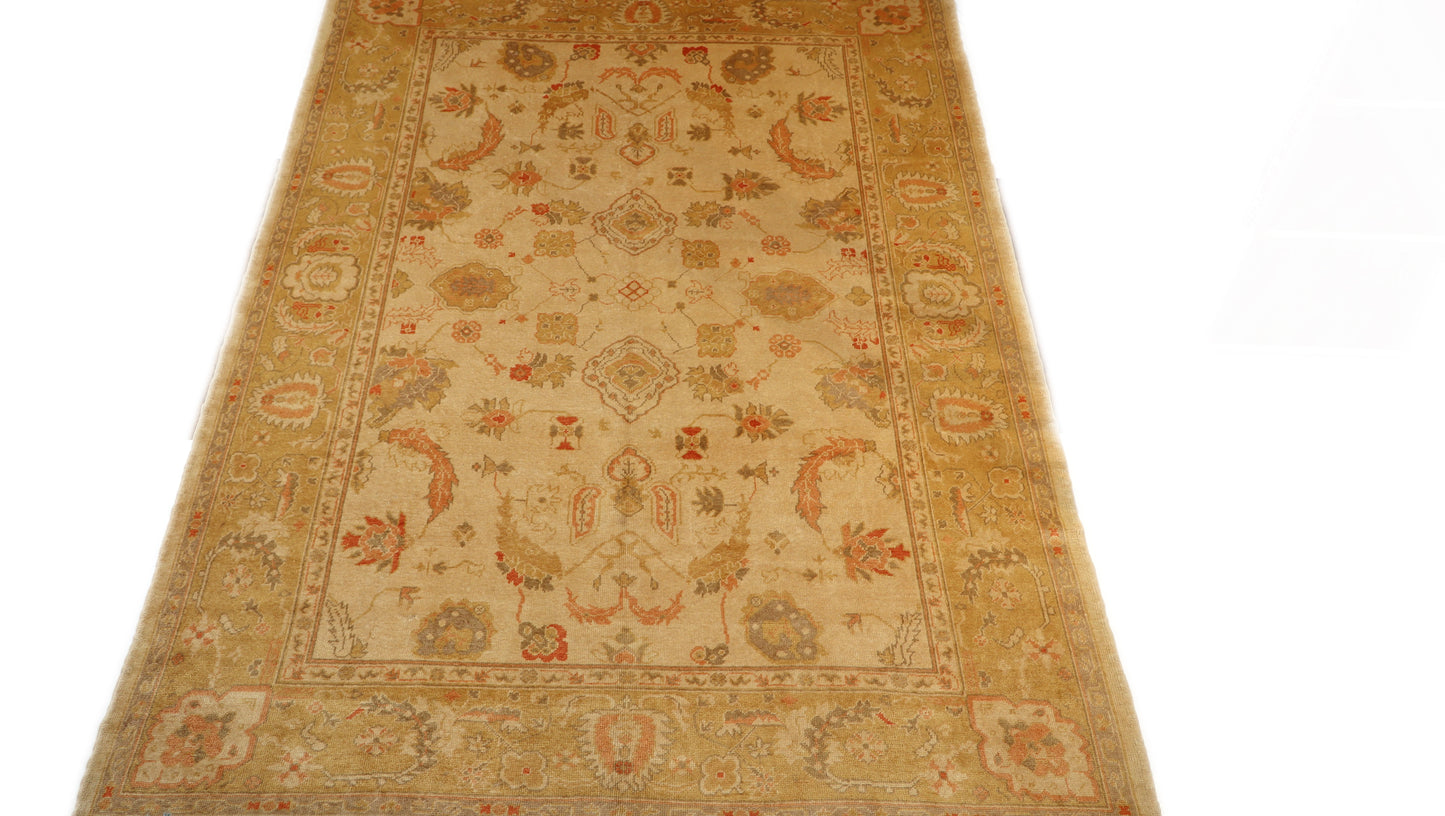 Hand-knotted mohair rug with a large knot and antique finish in oyster shell and sandy beige with dune grass green, rosehip pink, and gold accents.