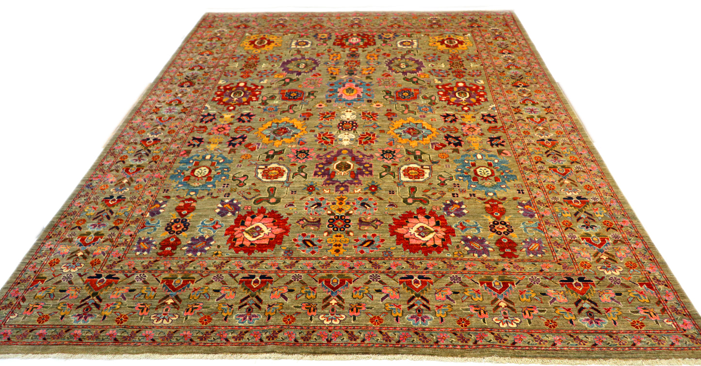 Hand-knotted wool rug with a weathered gray base and vibrant accents of sea glass blue, soft pink, purple, and gold.