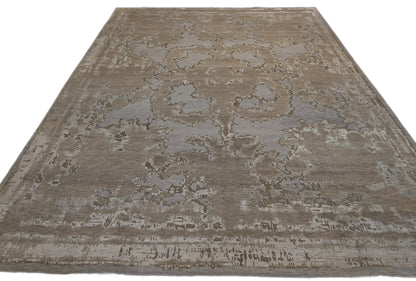 A hand-knotted wool and silk rug with a coastal-inspired design in shades of taupe, smokey blue, and soft grey.