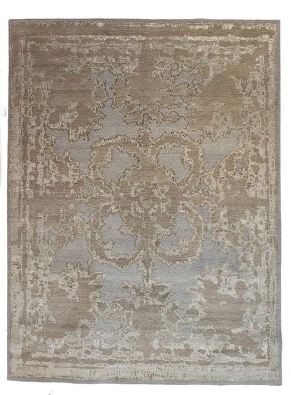 A hand-knotted wool and silk rug with a coastal-inspired design in shades of taupe, smokey blue, and soft grey.