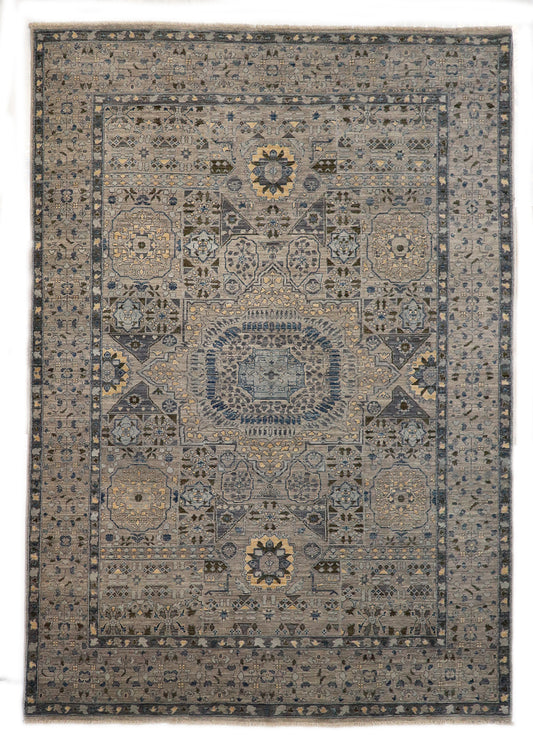 Hand-knotted intricate patterned rug in pebble gray, sea blue, and seafoam green with sand and gold accents.