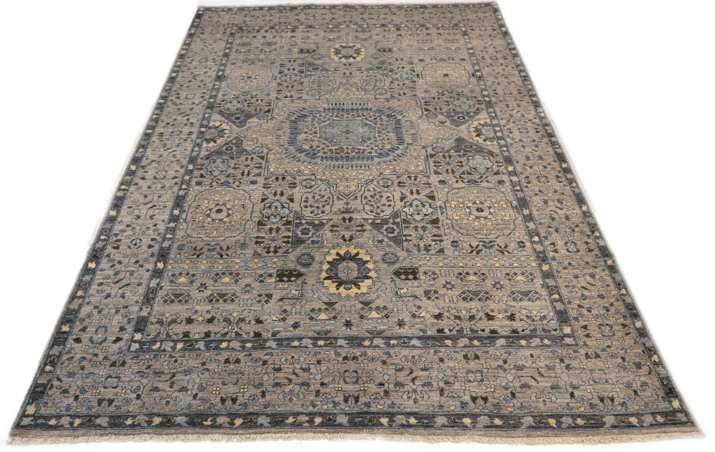Hand-knotted intricate patterned rug in pebble gray, sea blue, and seafoam green with sand and gold accents.
