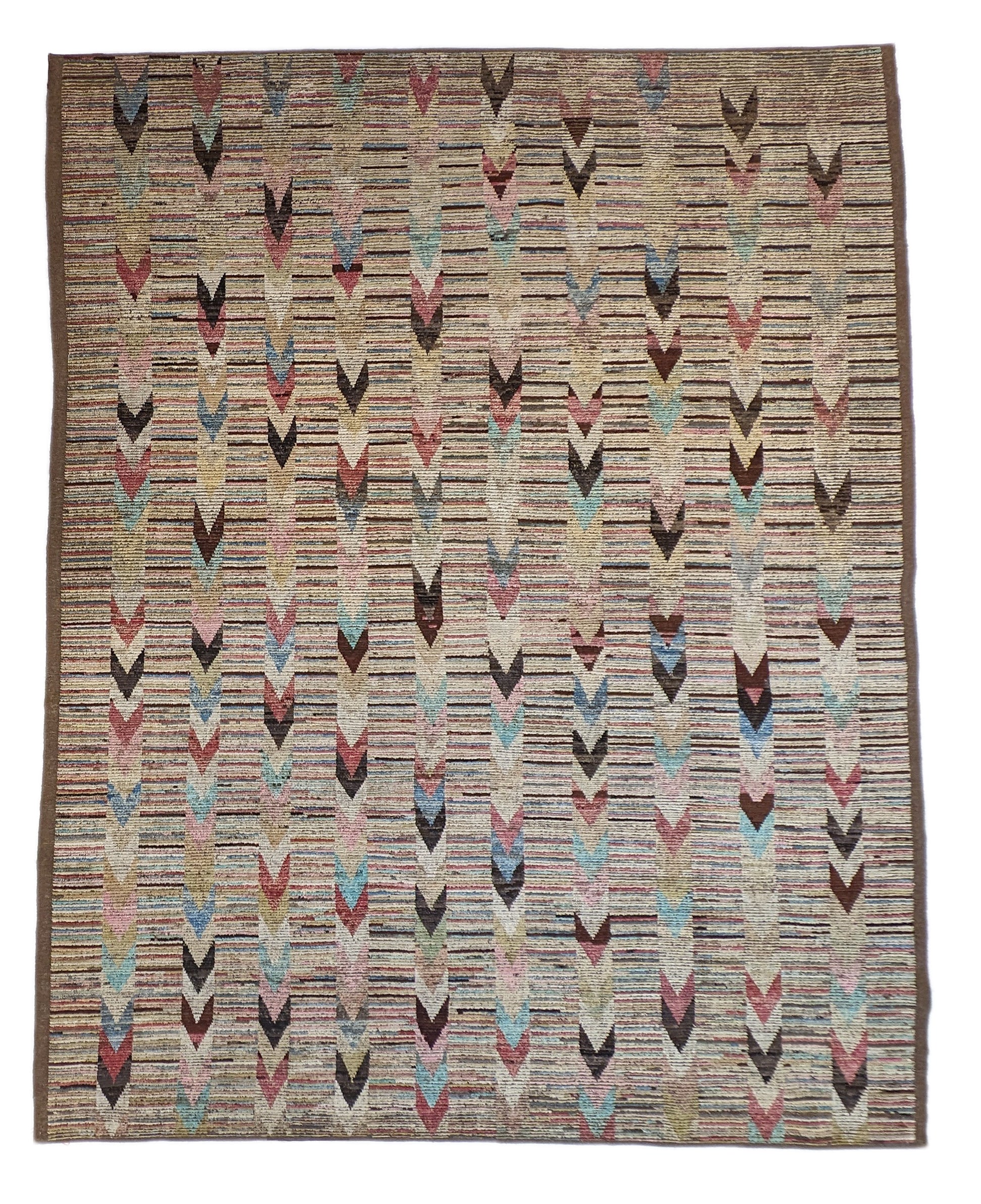 A hand-knotted wool rug with a coastal aesthetic in a plush design, featuring a mix of pink, red, yellow, blues, browns, and ivory colors.