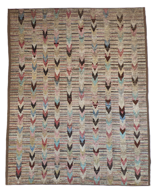A hand-knotted wool rug with a coastal aesthetic in a plush design, featuring a mix of pink, red, yellow, blues, browns, and ivory colors.