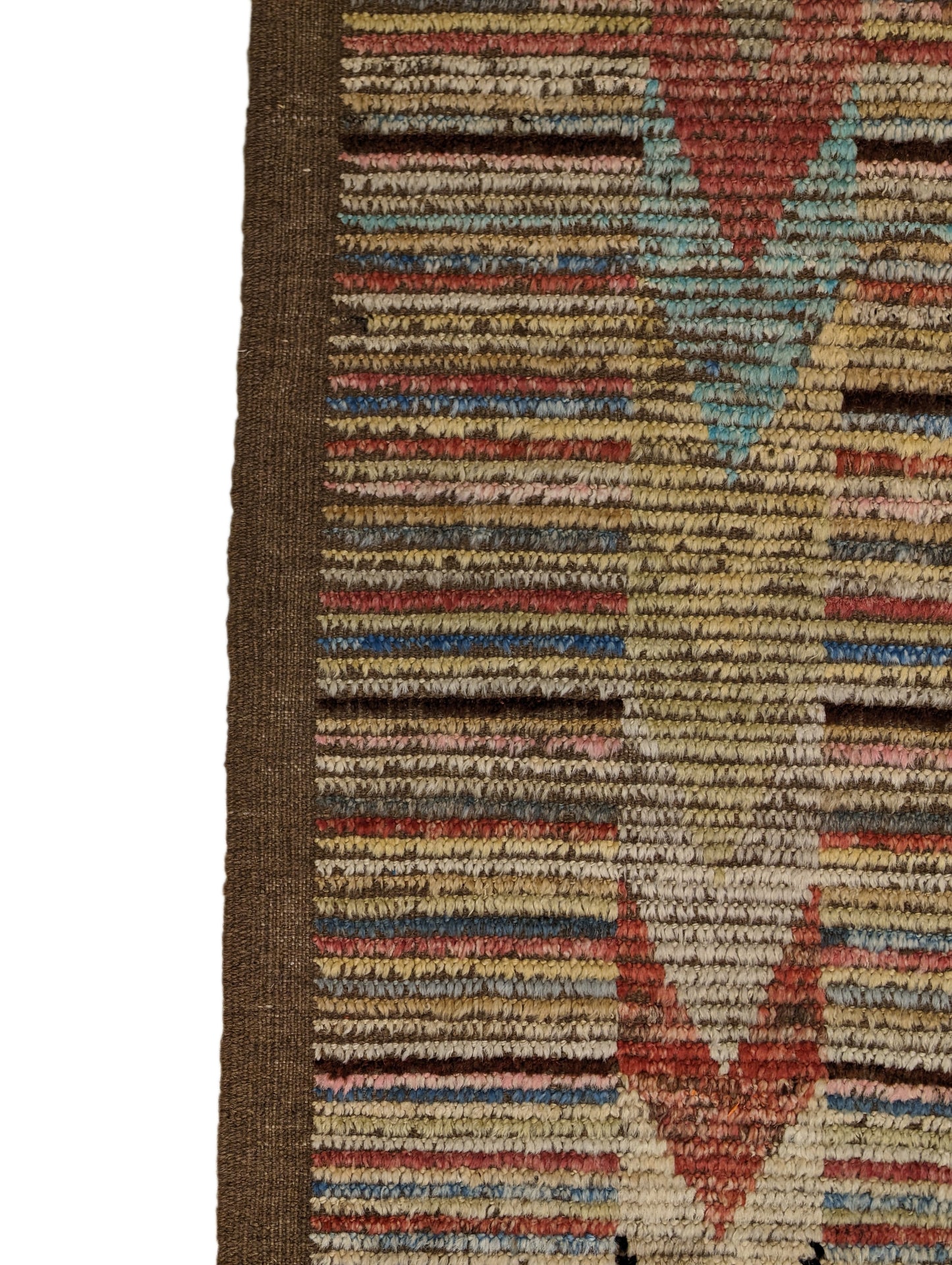 A hand-knotted wool rug with a coastal aesthetic in a plush design, featuring a mix of pink, red, yellow, blues, browns, and ivory colors.