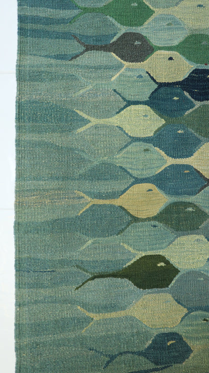 Hand-knotted wool kilim flatweave with a fish design in deep ocean blue, cerulean, and mangrove green.