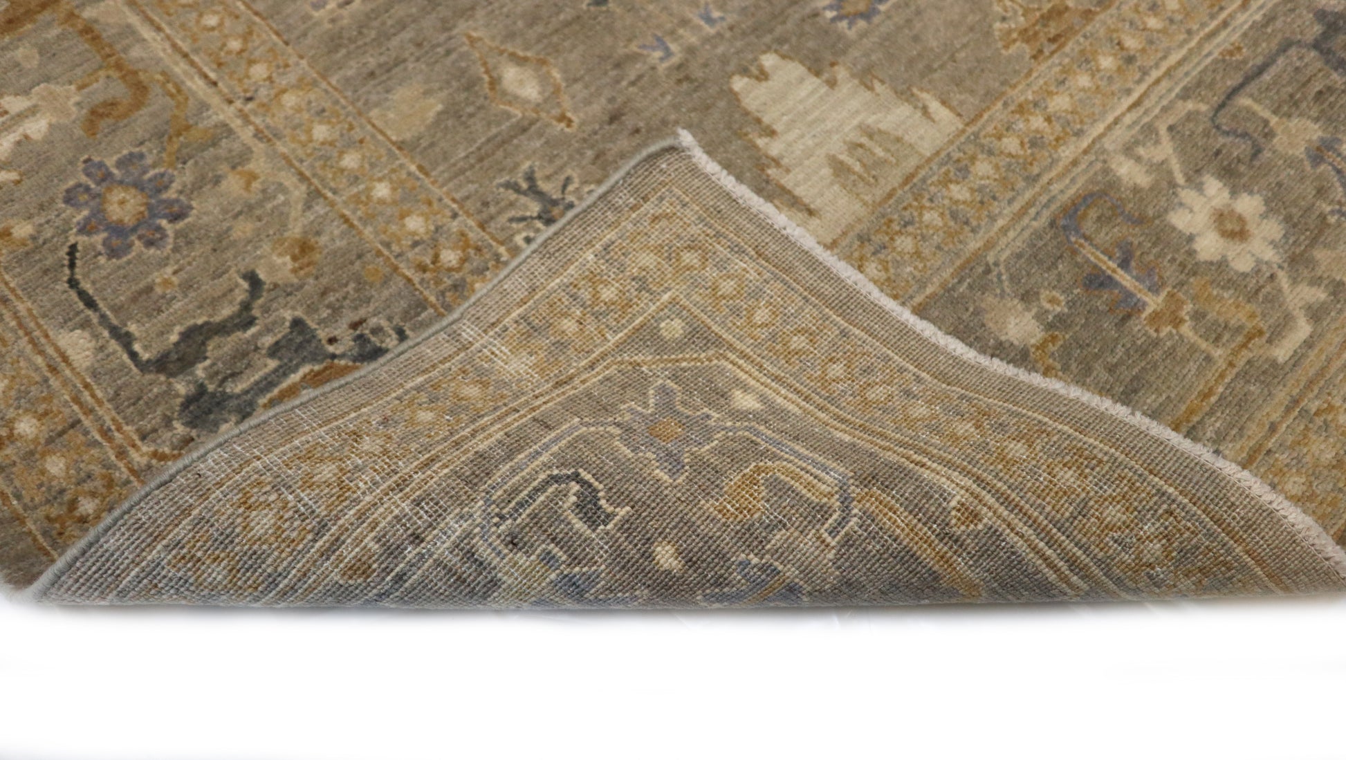 Hand-knotted wool rug in a traditional design featuring driftwood gray and sandy beige with sea glass blue and gold accents and a low pile.