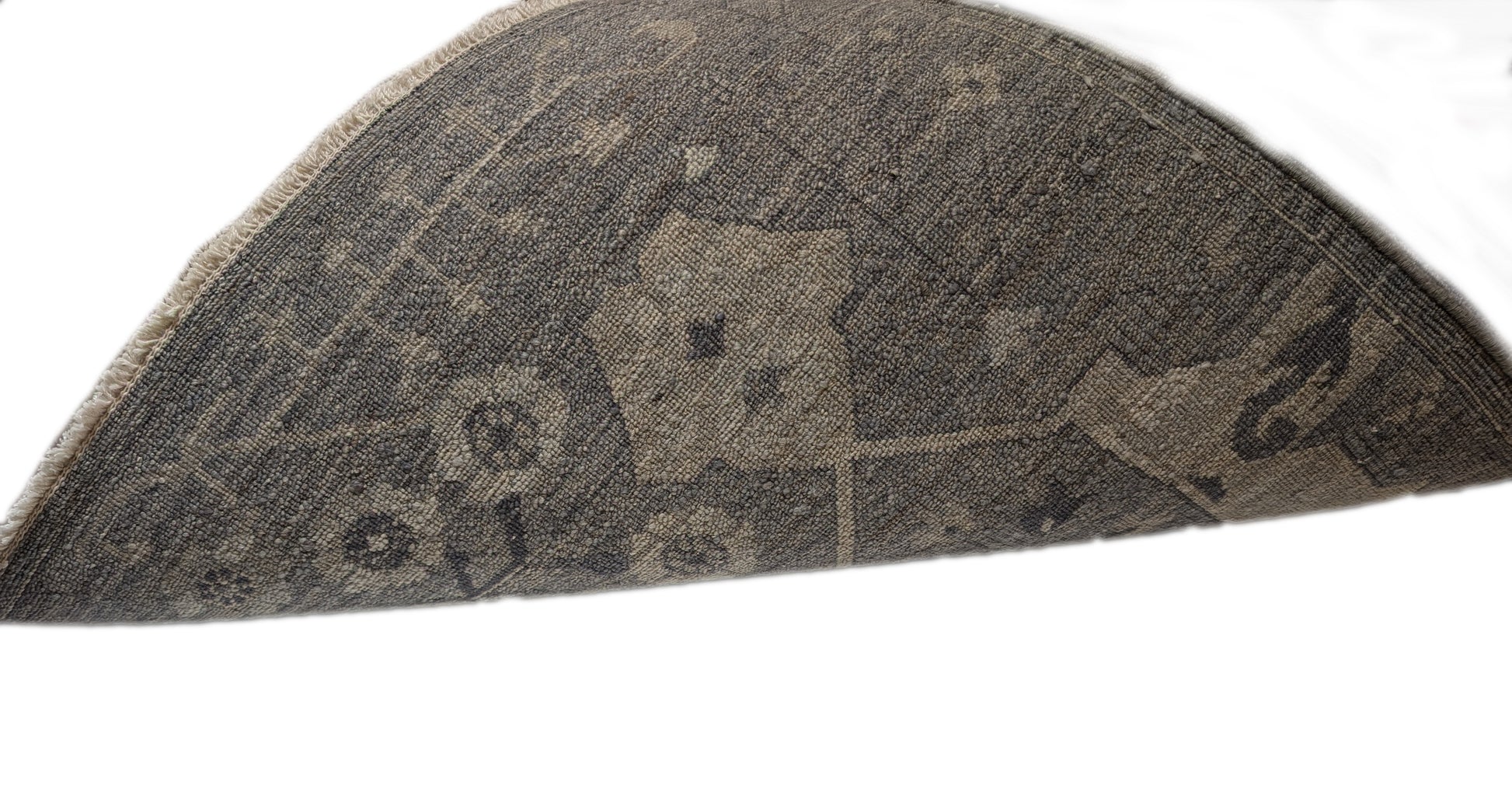 A hand-knotted wool rug with a traditional and contemporary design, featuring coastal shades of grey, smokey blue, ivory, and brown.