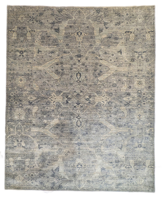 A hand-knotted wool rug with a traditional and contemporary design, featuring coastal shades of grey, smokey blue, ivory, and brown.