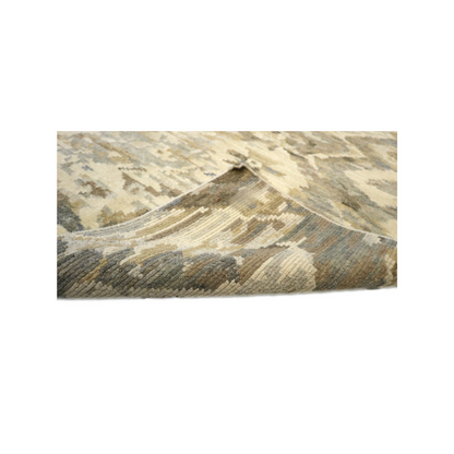 Hand- knotted patterned rug with geometric design in beige, brown, and gray tones. Cozy pile 