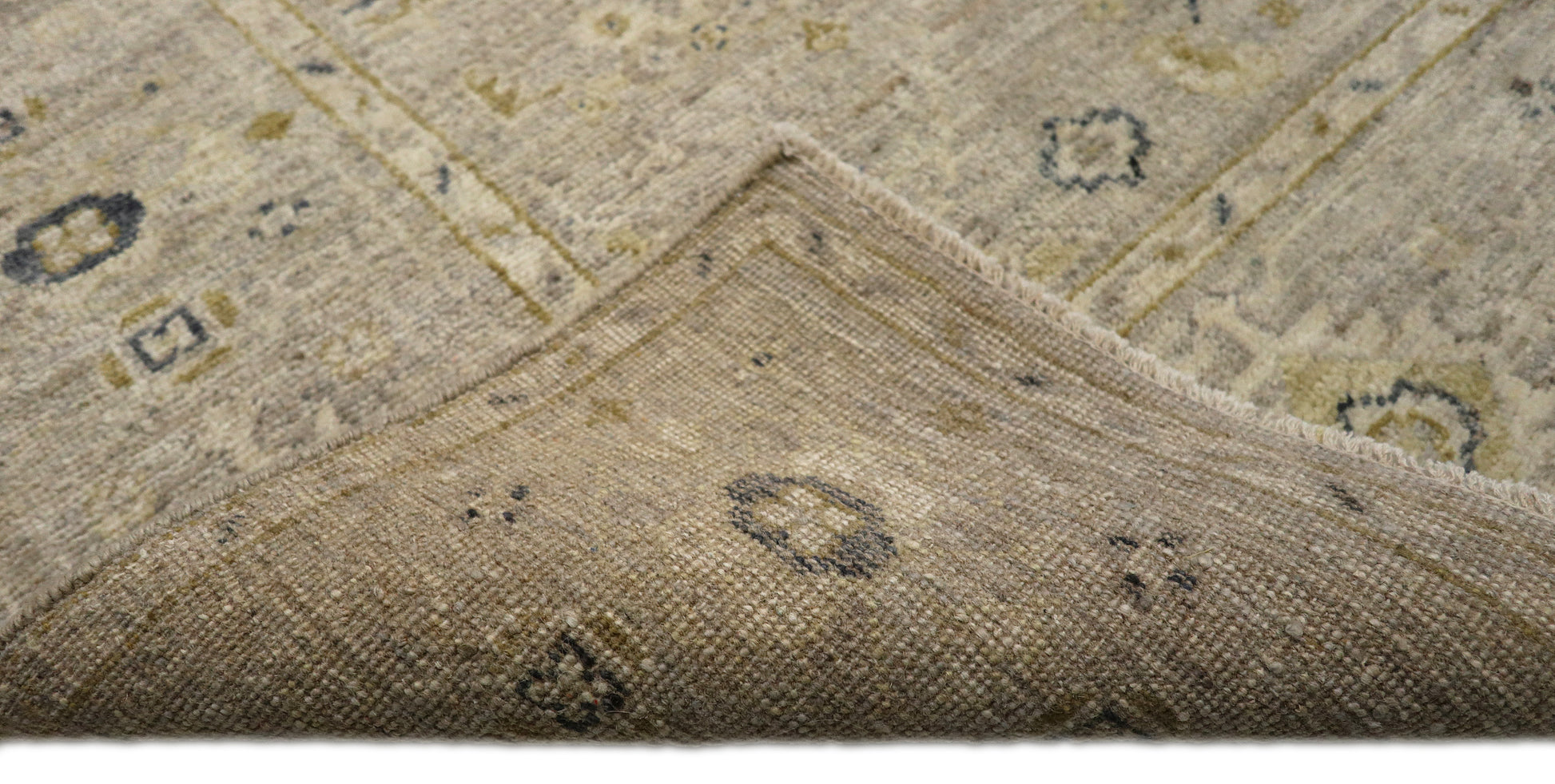 Hand-knotted wool rug with an antique finish in mist-gray, sand, and pale seagrass green with gold accents.