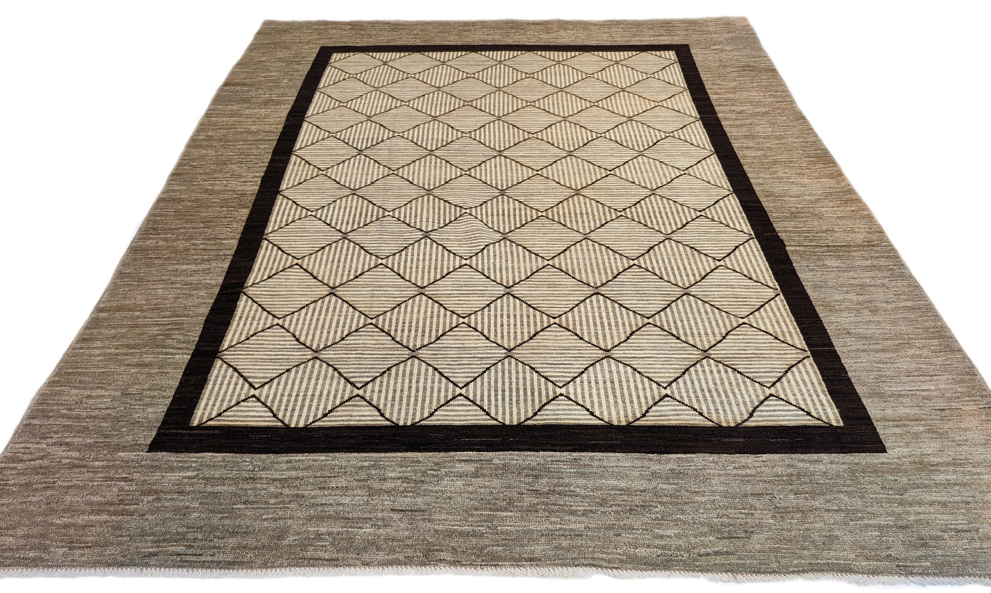 A hand-knotted wool rug with a geometric pattern in natural tones of beige, brown, and gray. Cozy pile. 
