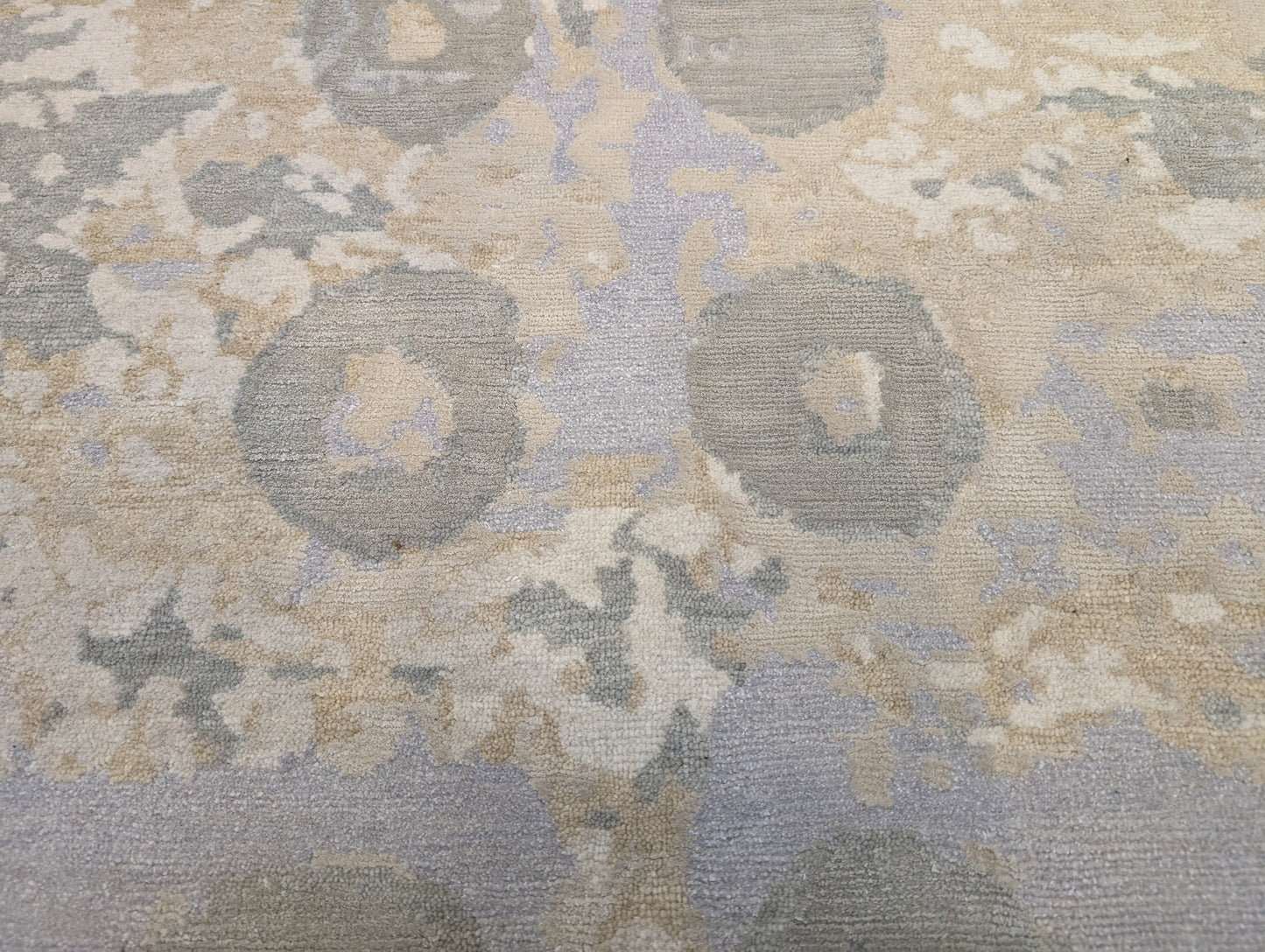 A hand-knotted wool and silk rug featuring a coastal aesthetic with serene coastal tones.
