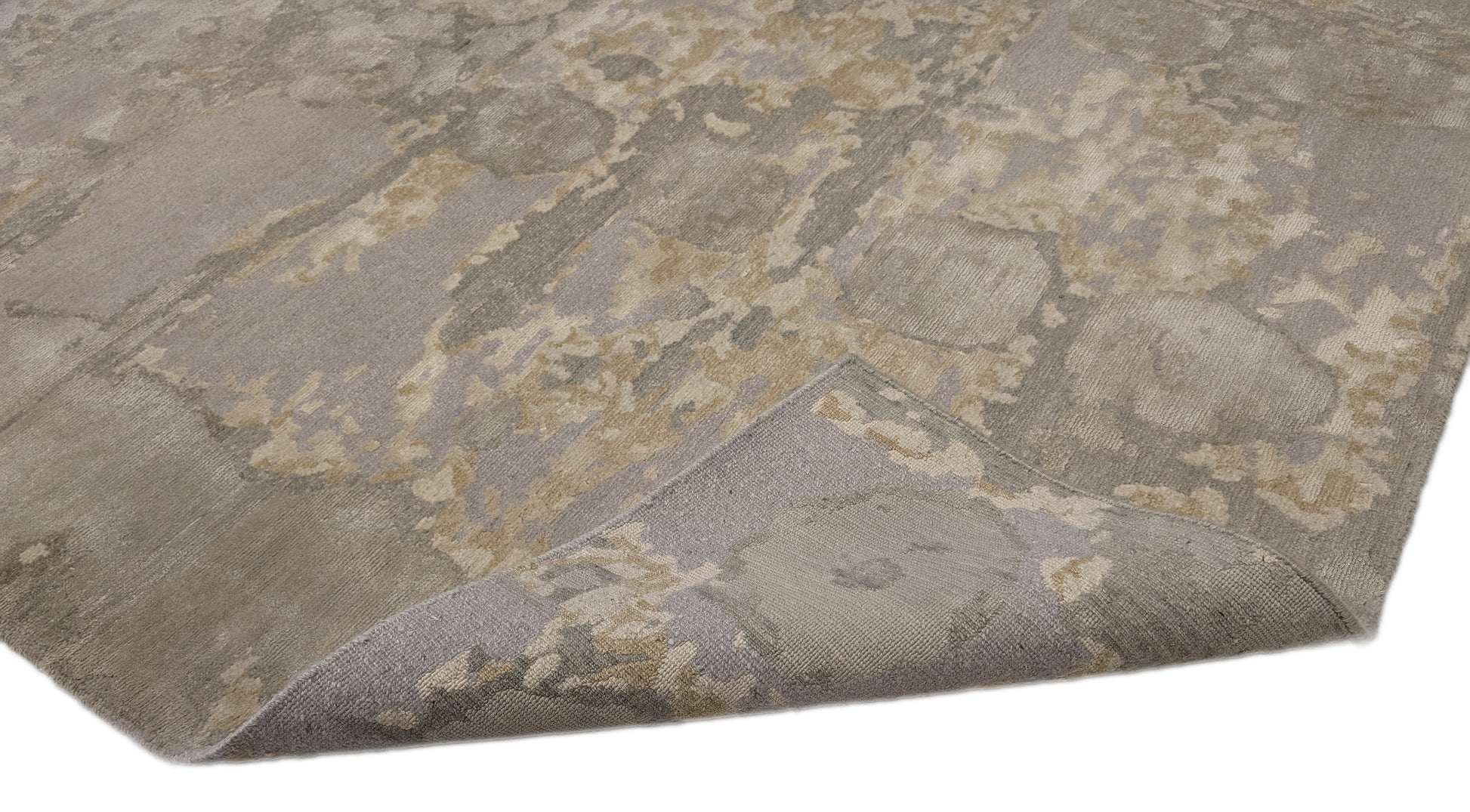 A hand-knotted wool and silk rug featuring a coastal aesthetic with serene coastal tones.