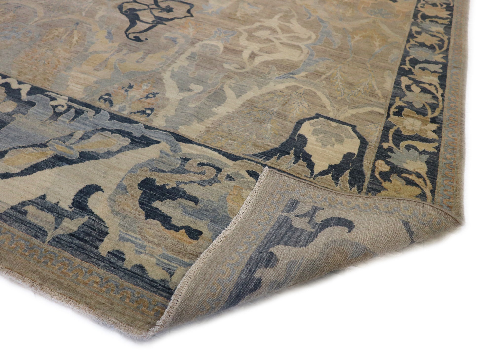 A hand-knotted wool rug with a coastal design featuring navy, ivory, sandy taupe, blue, peach, and yellow colors.