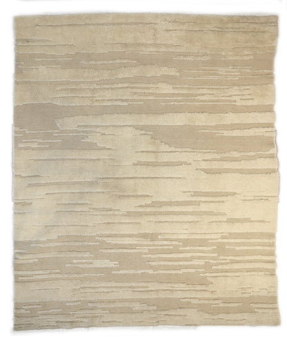 Hand-knotted high-low pile wool rug in natural undyed ivory and warm sandy beige with a large knot texture.