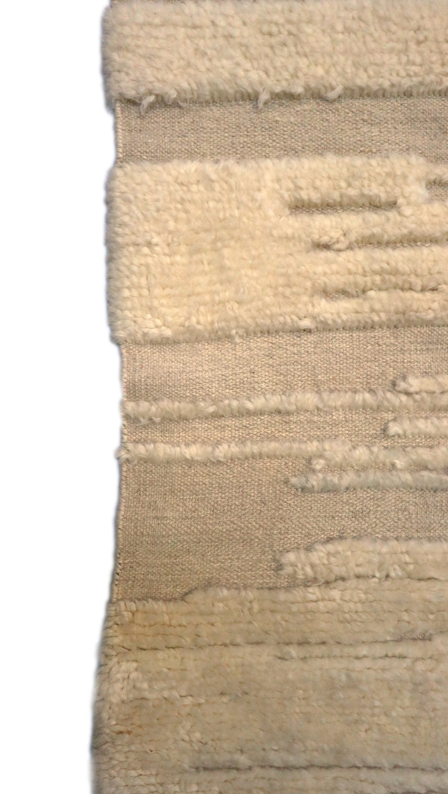 Hand-knotted high-low pile wool rug in natural undyed ivory and warm sandy beige with a large knot texture.