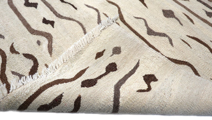 Hand-knotted wool kilim flatweave in sun-baked sand and earthy driftwood tones with deep brown accents
