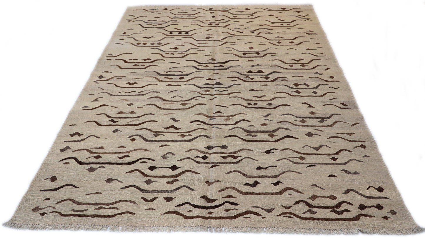 Hand-knotted wool kilim flatweave in sun-baked sand and earthy driftwood tones with deep brown accents