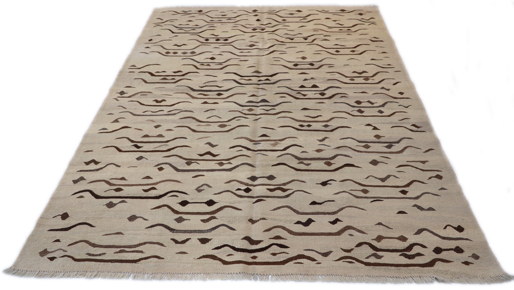 Hand-knotted wool kilim flatweave in sun-baked sand and earthy driftwood tones with deep brown accents