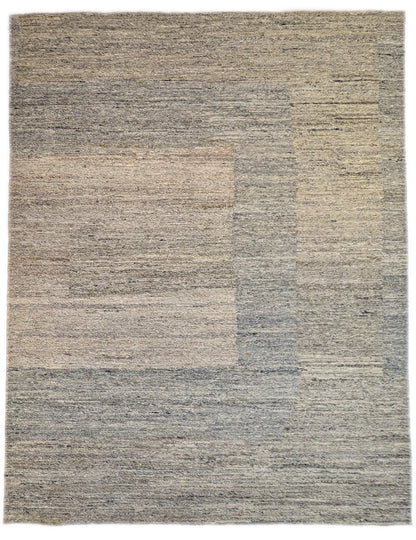 A hand-knotted wool rug with a coastal-inspired design in shades of light blue, beige, ivory, and brown. Cozy pile. 