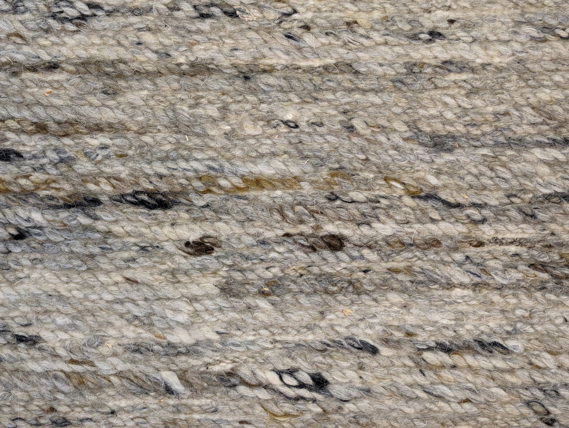 A hand-knotted wool rug with a coastal-inspired design in shades of light blue, beige, ivory, and brown. Cozy pile. 