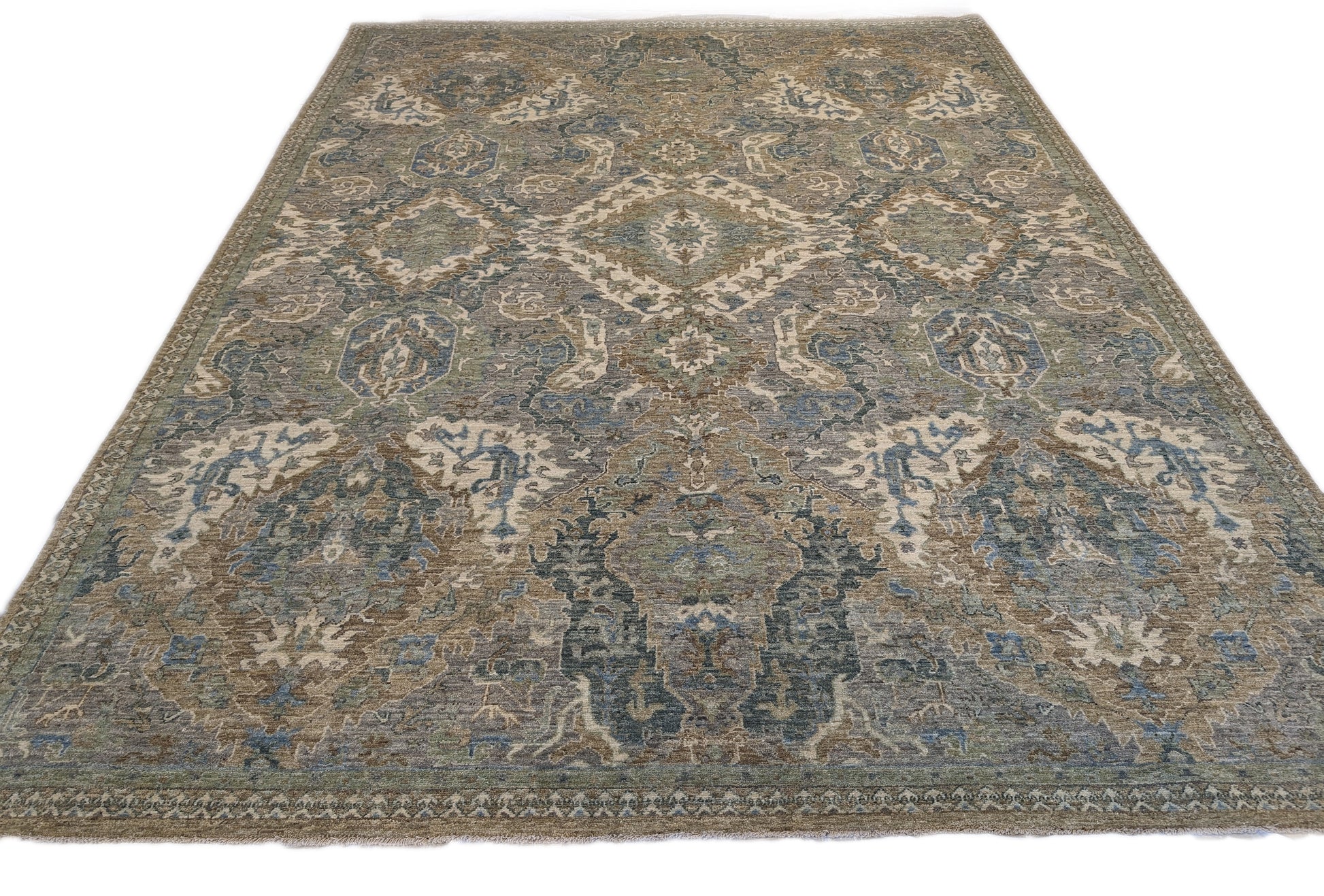 A hand-knotted wool rug featuring a traditional coastal lifestyle design with beige, blue, green, brown, gold, ivory, and grey colors.