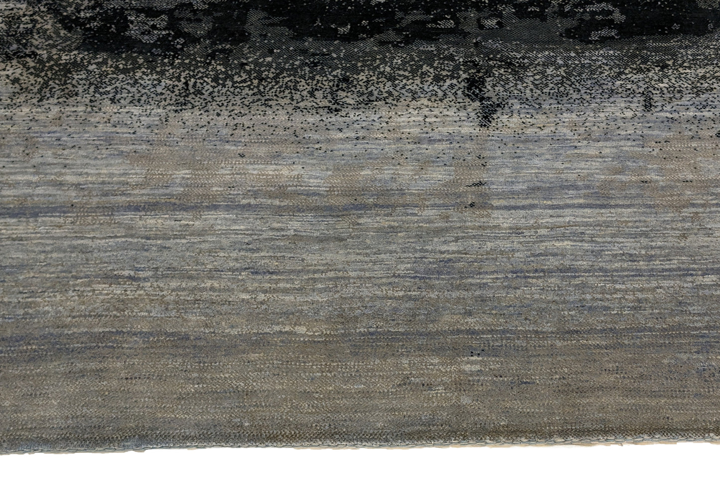A hand-knotted rug with a serene coastal aesthetic featuring shades of gray, blue, and green, and a unique hand-knotted design. Cozy wool and luxurious silk. 