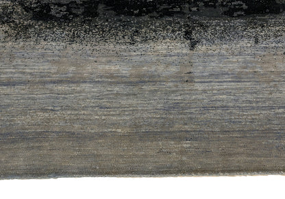 A hand-knotted rug with a serene coastal aesthetic featuring shades of gray, blue, and green, and a unique hand-knotted design. Cozy wool and luxurious silk. 