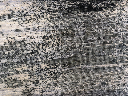 A hand-knotted rug with a serene coastal aesthetic featuring shades of gray, blue, and green, and a unique hand-knotted design. Cozy wool and luxurious silk. 