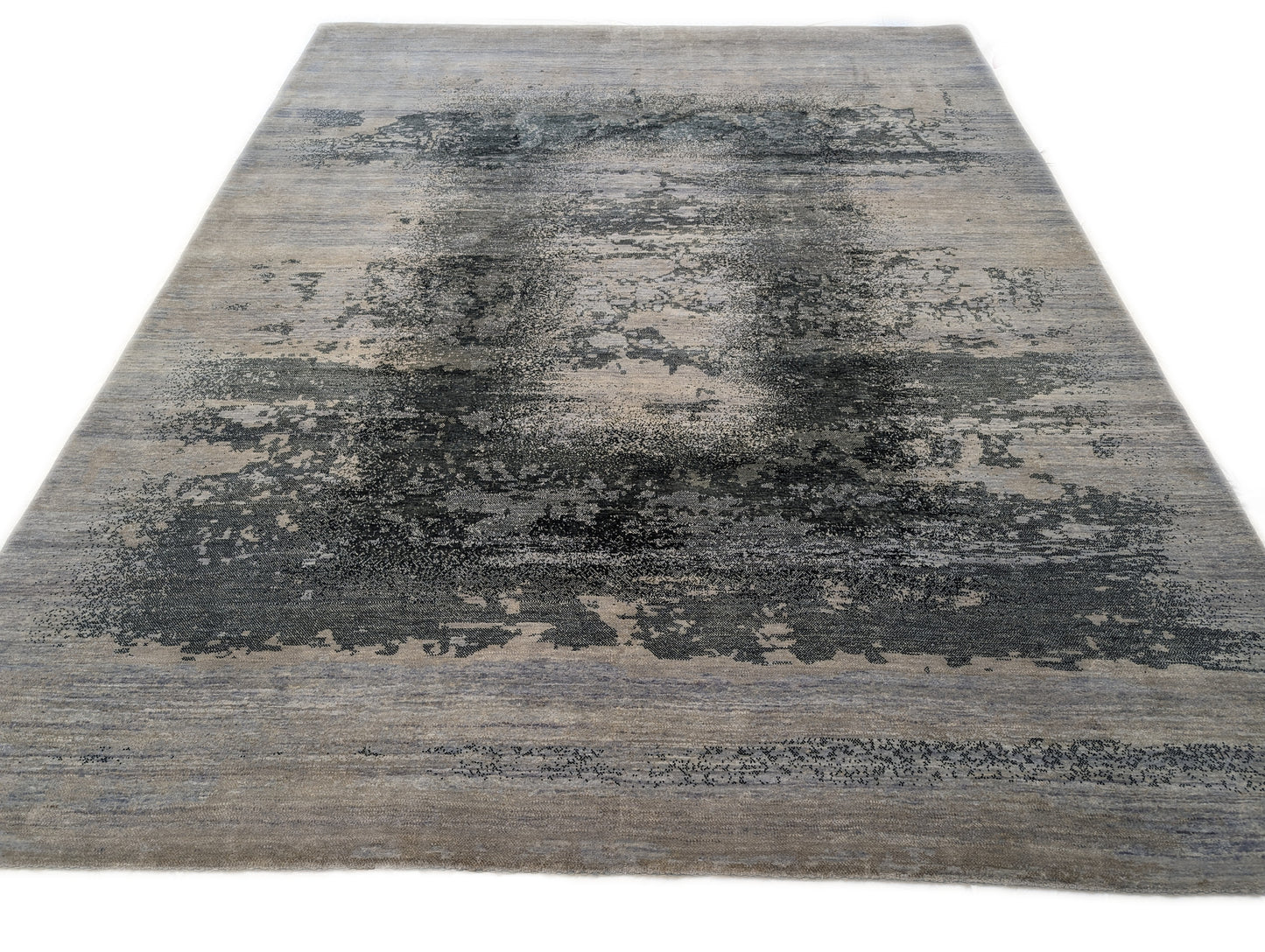 A hand-knotted rug with a serene coastal aesthetic featuring shades of gray, blue, and green, and a unique hand-knotted design. Cozy wool and luxurious silk. 