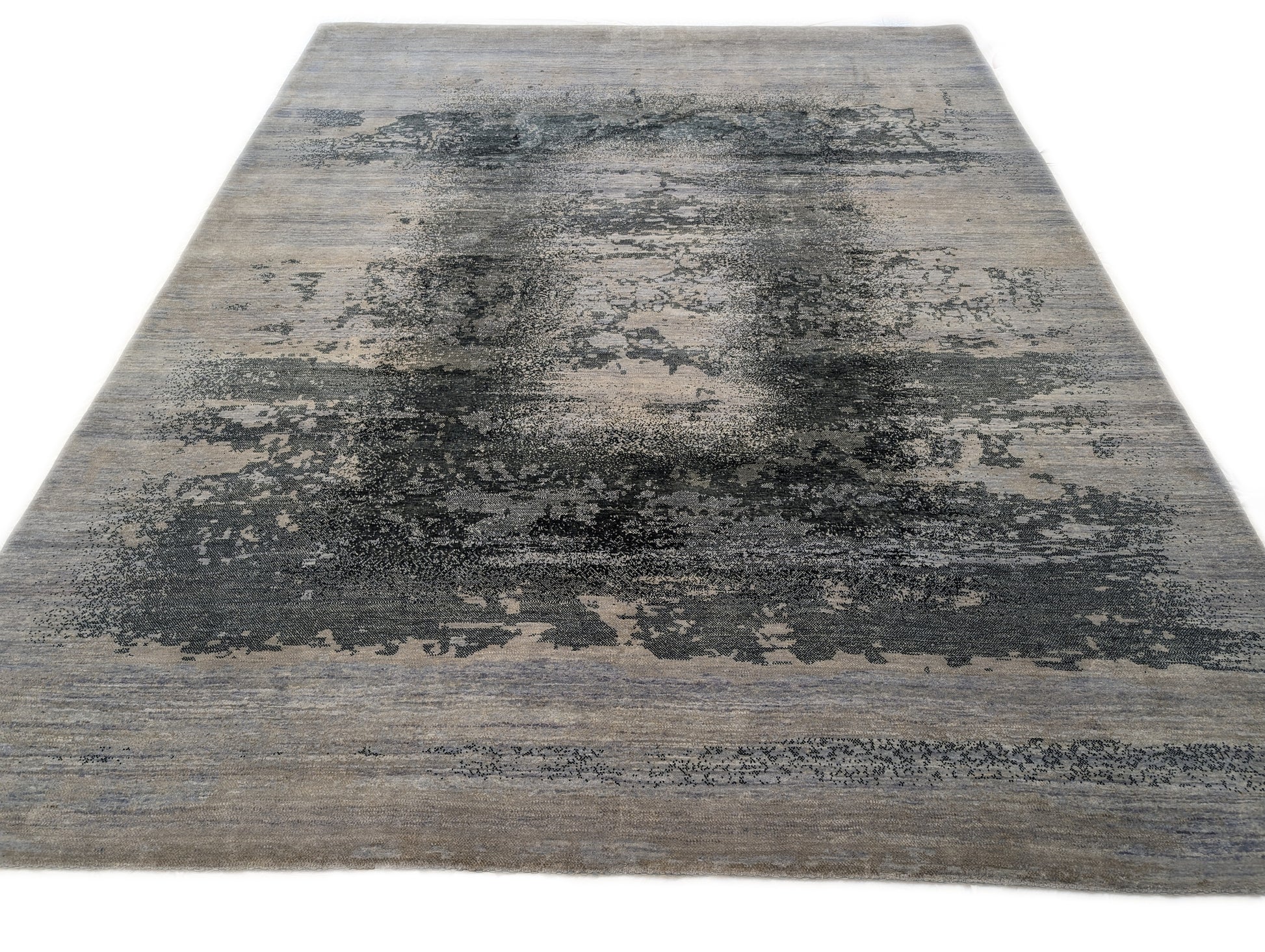 A hand-knotted rug with a serene coastal aesthetic featuring shades of gray, blue, and green, and a unique hand-knotted design. Cozy wool and luxurious silk. 