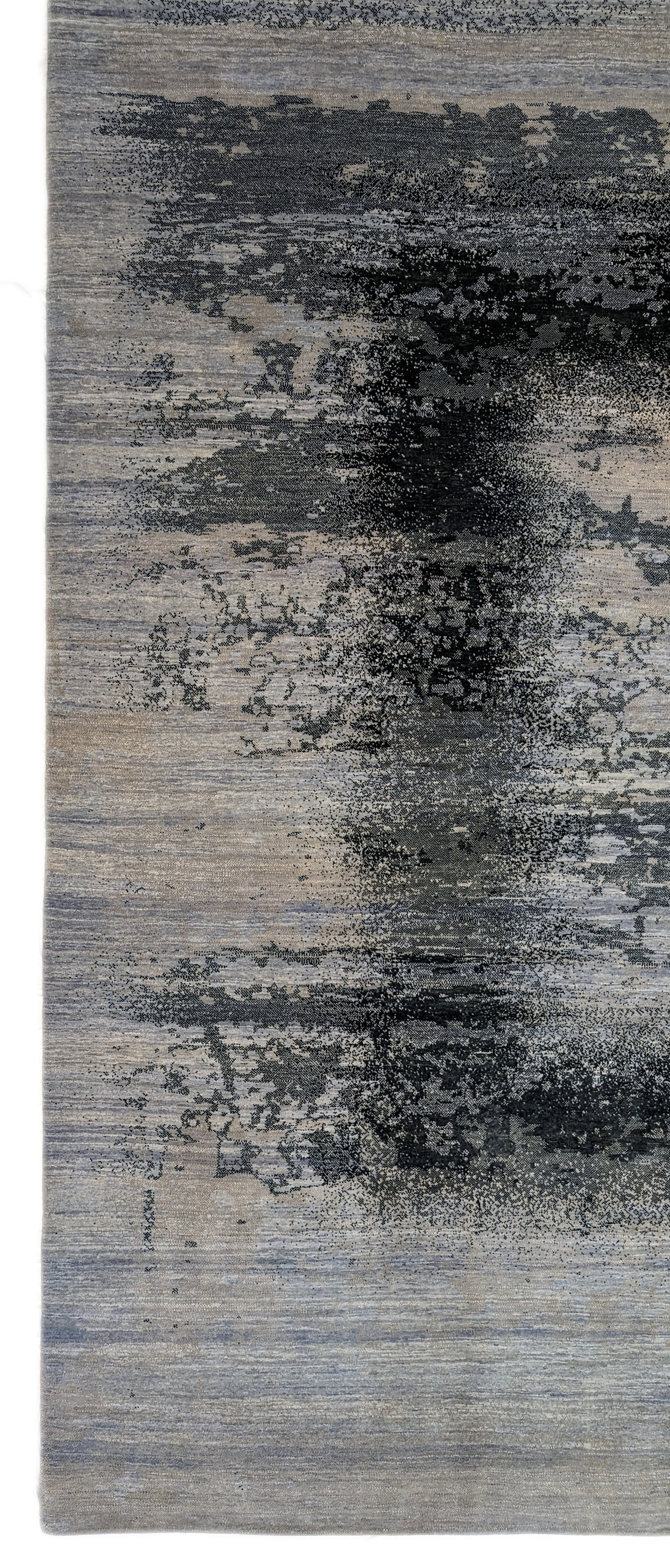 A hand-knotted rug with a serene coastal aesthetic featuring shades of gray, blue, and green, and a unique hand-knotted design. Cozy wool and luxurious silk. 