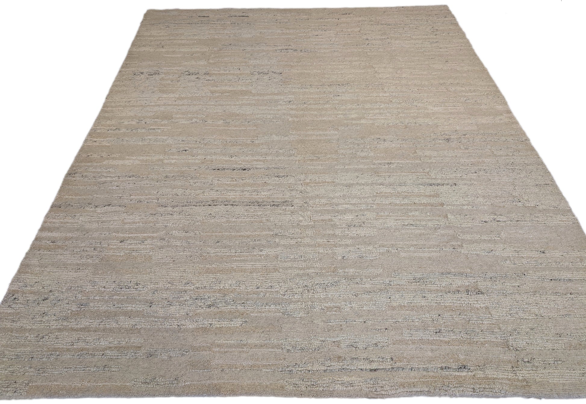 A beige hand-knotted rug with a coastal aesthetic from the Carmel-by-the-Sea Collection.