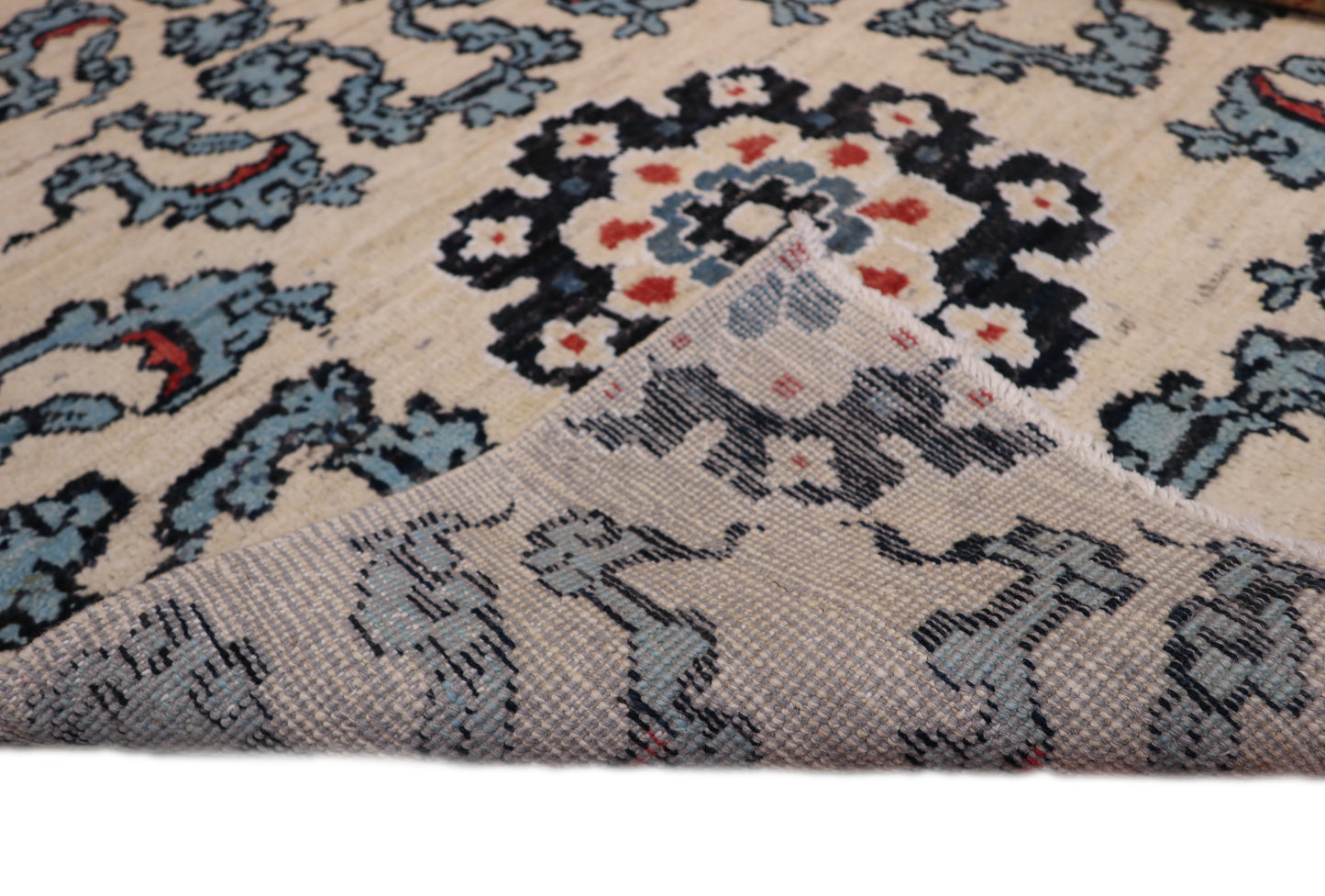 A hand-knotted rug with a coastal aesthetic, featuring a larger knot and higher pile. It has a vivid palette of turquoise, coral, and navy, with serene tones of ivory and white.