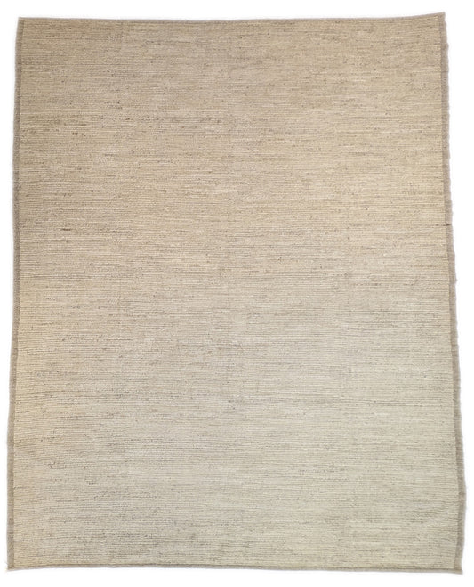 A hand-knotted wool rug in beige, ivory, and cream colors with a coastal aesthetic and a plush appearance.