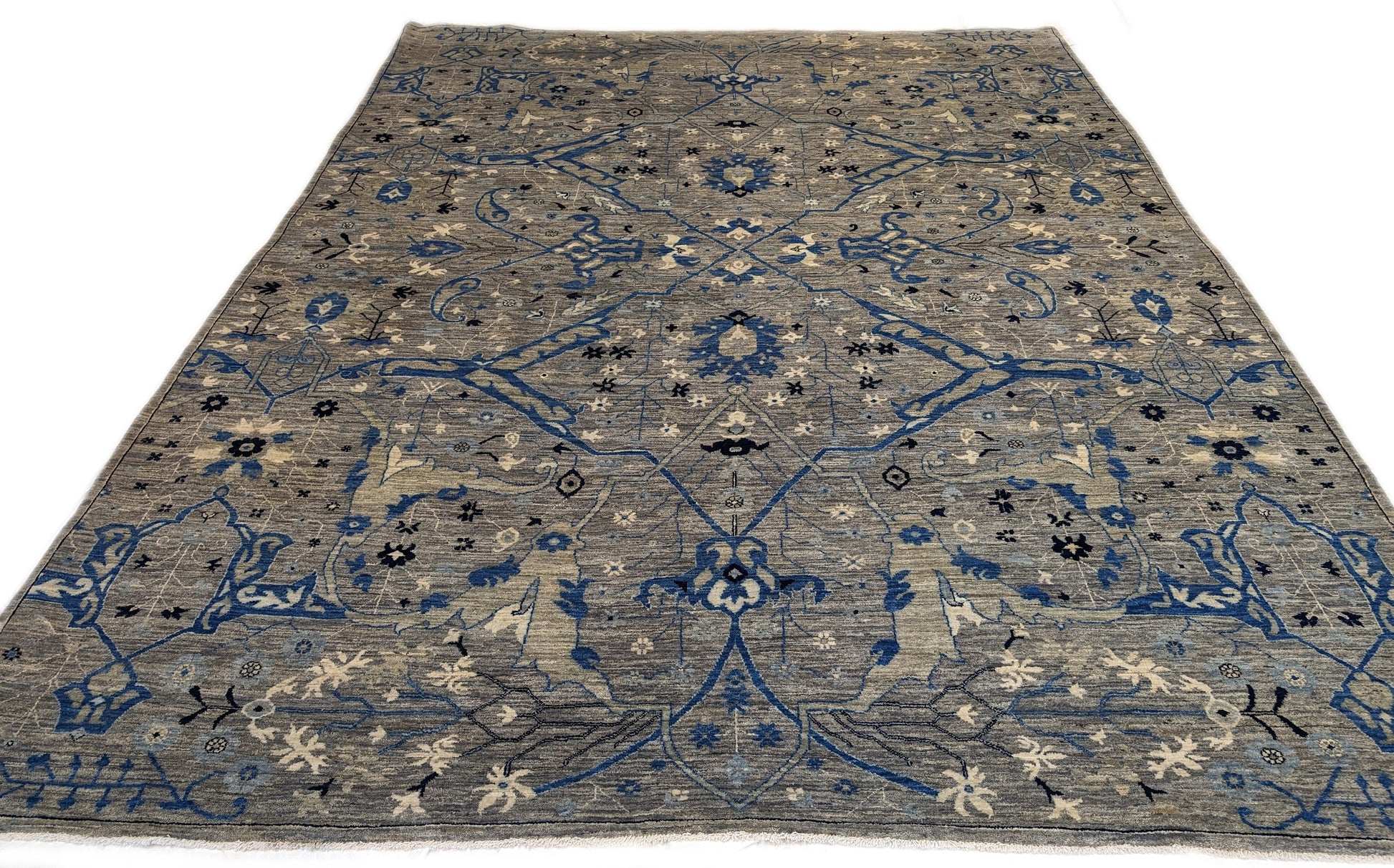 A hand-knotted wool rug with a coastal color palette, featuring traditional and contemporary geometric patterns.