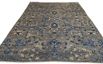 A hand-knotted wool rug with a coastal color palette, featuring traditional and contemporary geometric patterns.