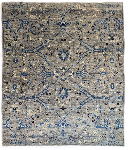 A hand-knotted wool rug with a coastal color palette, featuring traditional and contemporary geometric patterns.
