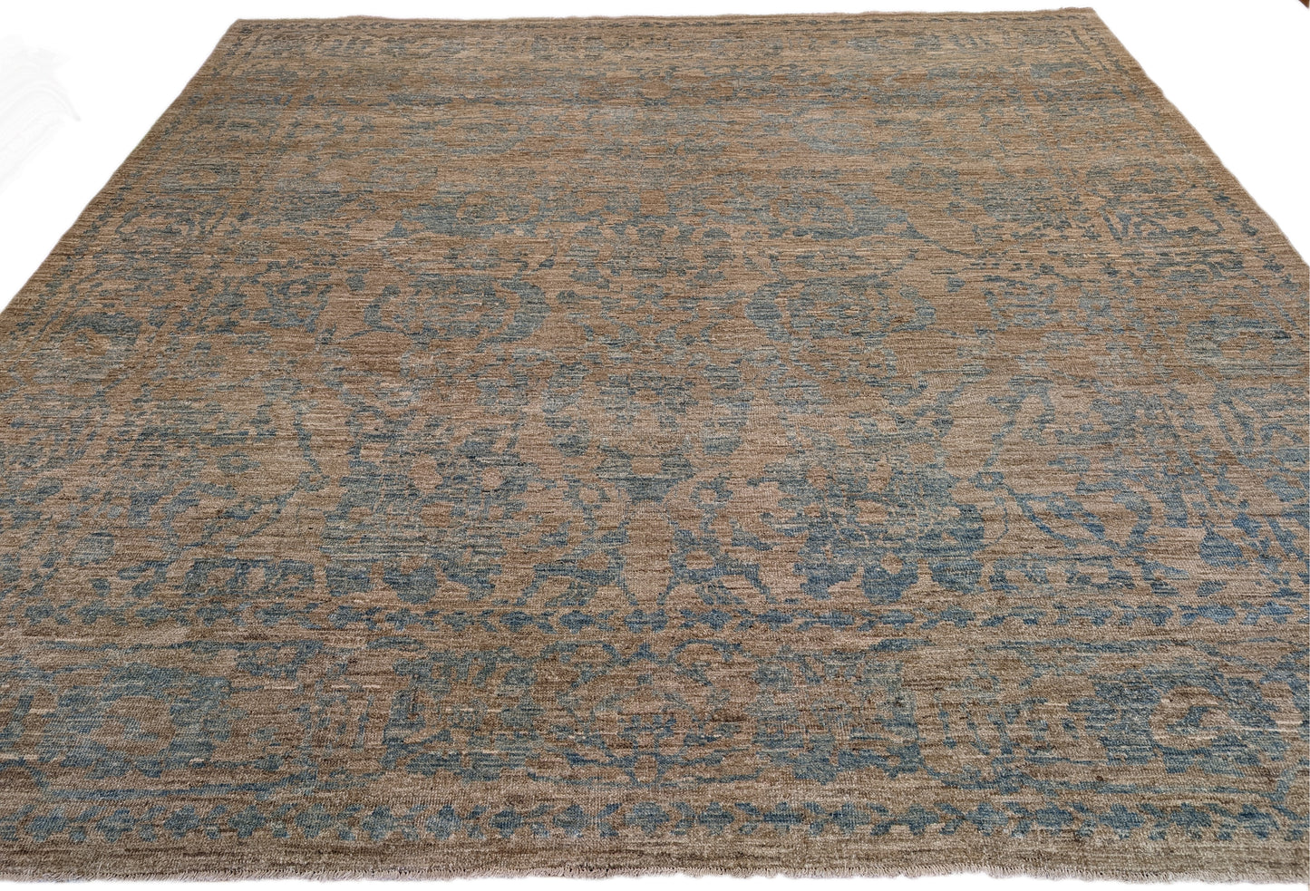 A hand-knotted low pile wool rug with a coastal-inspired design in natural tones of sandy brown and a subtle hint of aquamarine.