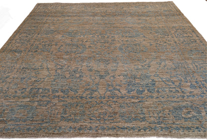 A hand-knotted low pile wool rug with a coastal-inspired design in natural tones of sandy brown and a subtle hint of aquamarine.