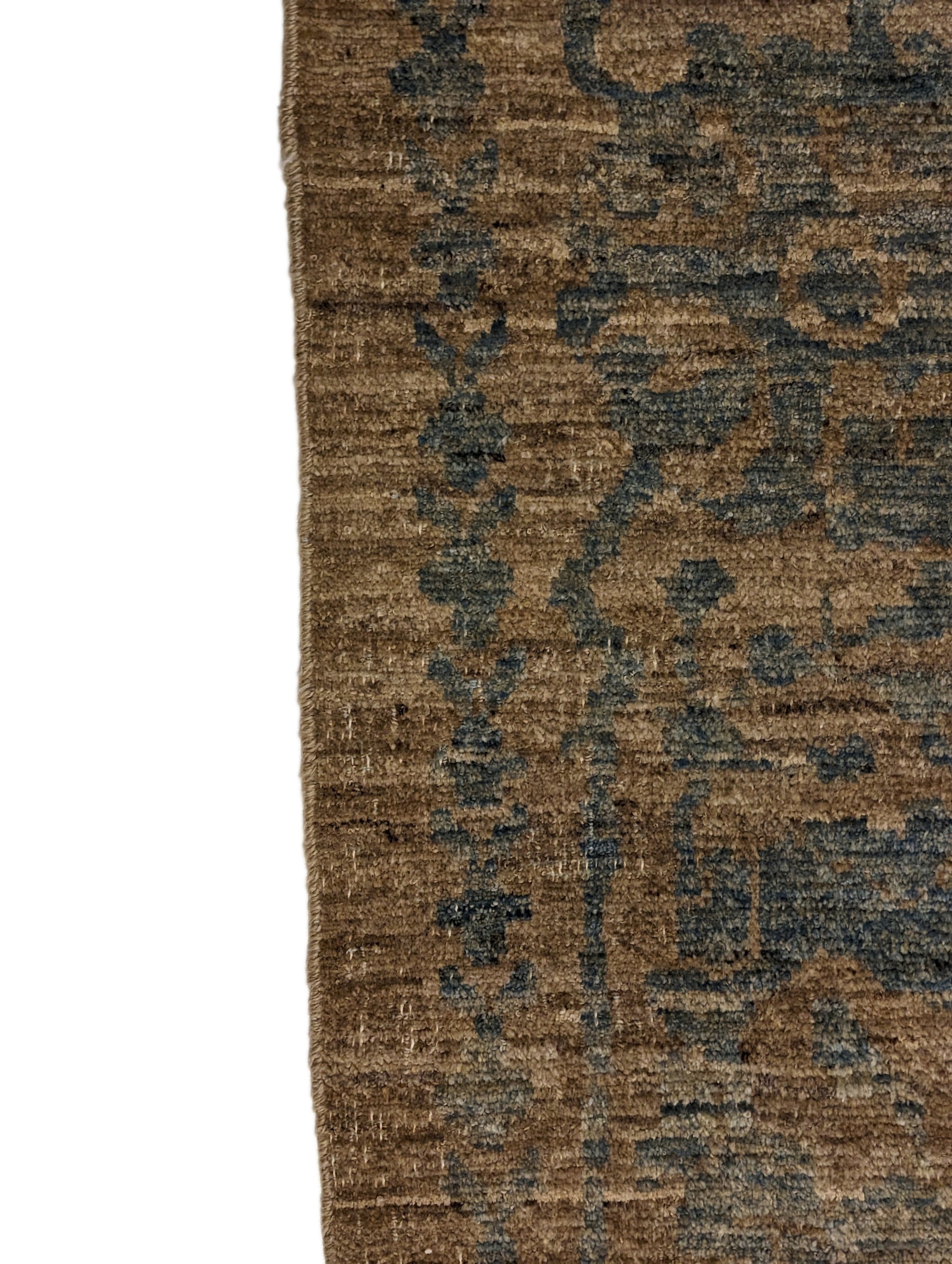 A hand-knotted low pile wool rug with a coastal-inspired design in natural tones of sandy brown and a subtle hint of aquamarine.