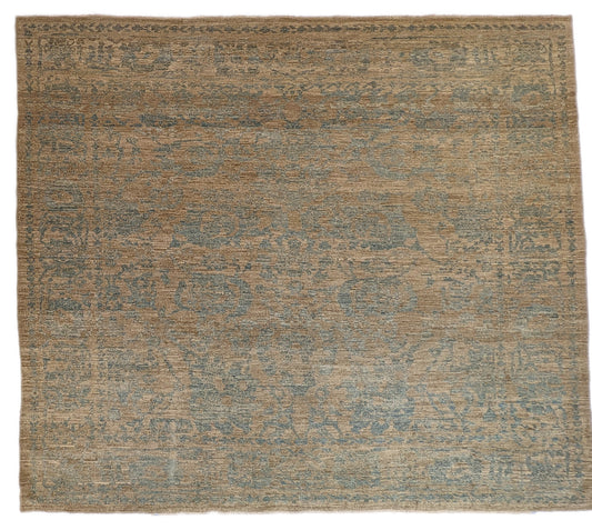 A hand-knotted low pile wool rug with a coastal-inspired design in natural tones of sandy brown and a subtle hint of aquamarine.