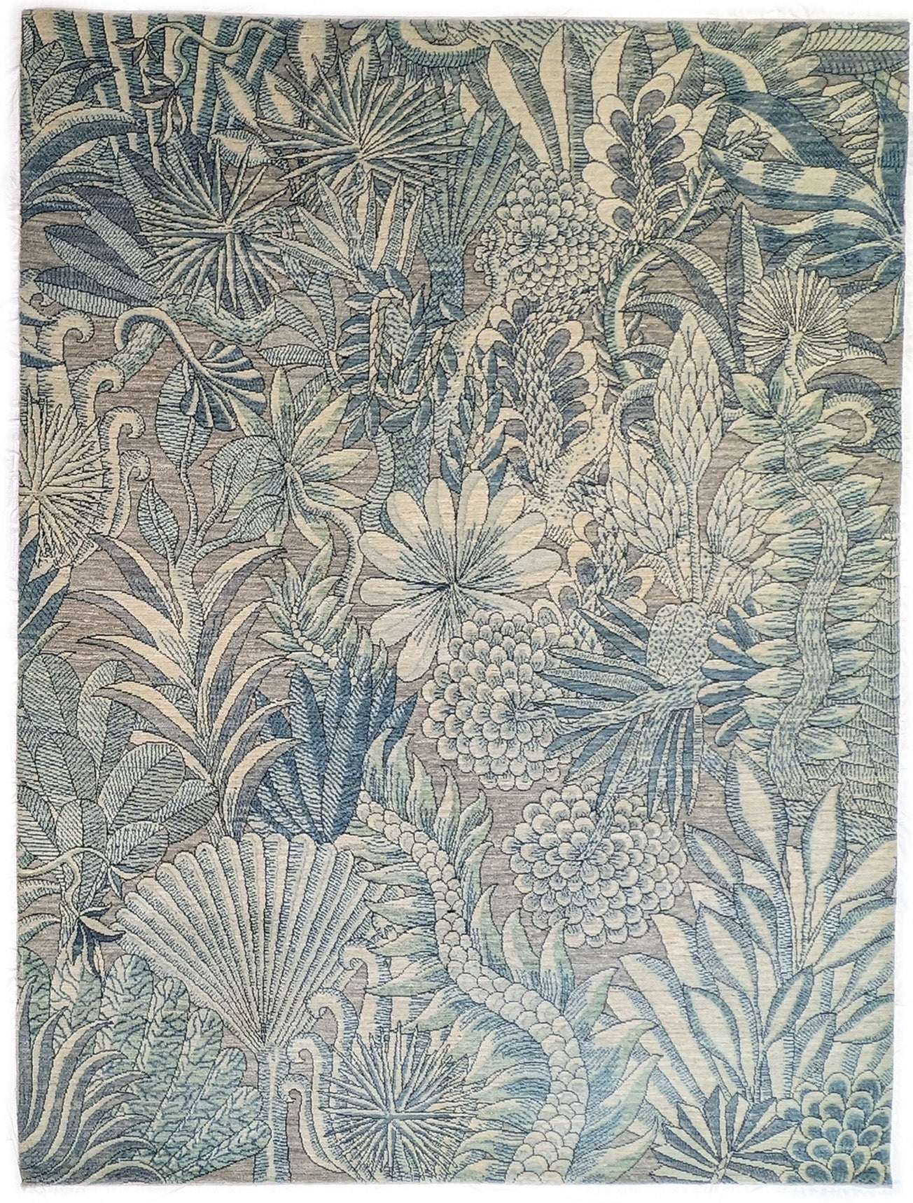 A hand-knotted wool rug with a coastal-inspired floral and plant design in shades of beige, gray, blue, green, and black.