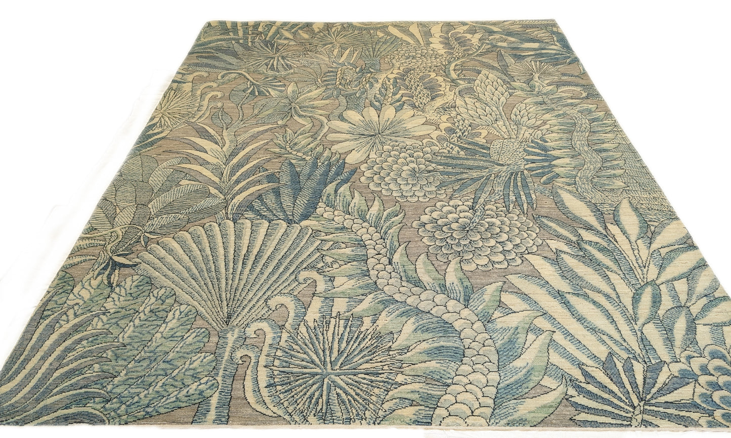 A hand-knotted wool rug with a coastal-inspired floral and plant design in shades of beige, gray, blue, green, and black.