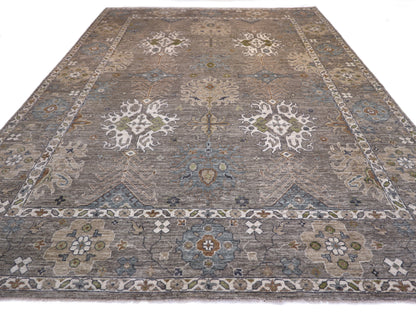 A hand-knotted wool rug with a coastal design in shades of grey, blue, ivory, brown, orange, green, and taupe.